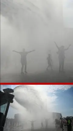 පුද්ගලයන් තිදෙනෙකු අත් ඔසවාගෙන වැස්සක් අවස්ථාවක මෙන් තෙමෙන අයුරු පෙනේ.