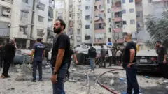 High rise building wey Israeli air strike hit for Beirut as pipo dey inspect di damage to di blocks of flats for di southern suburbs of di Lebanese capital.