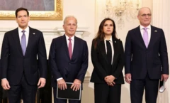 Biri kadın dört resmi giysili yetkili gazetecilere poz veriyor. 