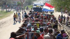 Os moradores de Puerto Casado na caçamba de um caminhão durante marcha