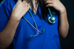 Young female doctor in surgical scrubs with a stethoscope