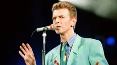 La estrella del pop británico David Bowie canta en el micrófono en el concierto tributo a Freddie Mercury para la concientización sobre el SIDA en Wembley en 1992.