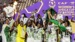 Women celebrate as dem lift trophy