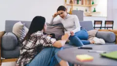 Duas mulheres conversando na sala de estar de uma casa