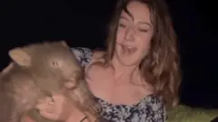 The woman holding the wombat
