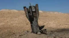 Part of bomb wey don already explode wey comeout from ground