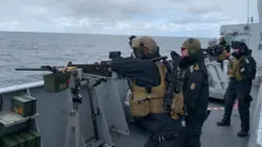 Reclutas y oficiales apuntan con armas en un ejercicio militar