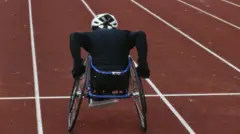 Young male wheelchair track athlete on track