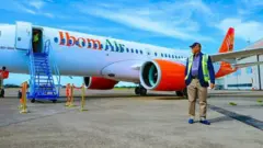Pesin stand in front of Ibom Air