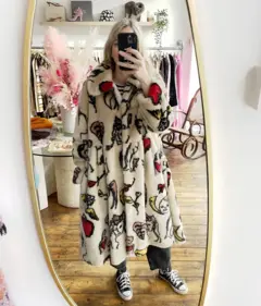 Mulher vestindo um casaco branco de pele com estampas