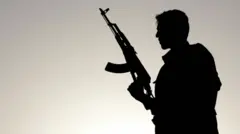 A silhouette of a man holding a machine gun