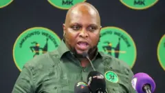 Floyd Shivambu from South Africa's MK Party is seen addressing the media in a green shirt bearing his party's logo