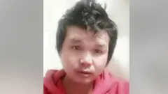 Photograph of Suthisak Rintalak. His hair is styled pointing up and he is wearing a red hoodie