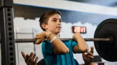niño alzando pesas 