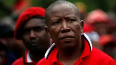 Julius Malema Economic Freedom fighters dey always wear red berets and red boiler suits