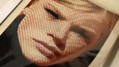 Picture in an album showing an artistic headshot of a young blonde woman looking into the camera.