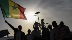Young pipo hold Senegal flag during match