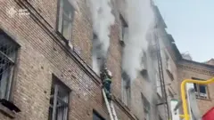 A firefighter works at the site of a Russian attack, amid Russia's attack on Ukraine, in a location given as Kyiv, Ukraine,
