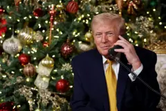 US President Donald Trump calls children as he participates in tracking Santa Claus' movements with the North American Aerospace Defense Command (NORAD) Santa Tracker on Christmas Eve at the Mar-a-Lago resort on December 24, 2025 in Palm Beach, Florida.