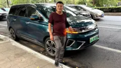 Lu Yunfeng junto a su vehículo eléctrico