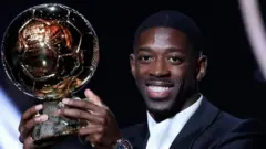 Ousmane Dembele pose wit im Ballon d'Or 2025 trophy