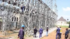Officials gather round electricity infrastructure