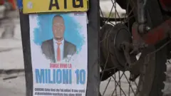 A close-up of a poster attached to the back of a motorbike that is offering a reward for information about a missing person. The portrait of the missing person in a dark jacket and red tie is on the poster.
