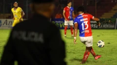 Edgar Medrano, atacante do FAS, chuta a bola de costas. Sua camisa mostra o número 13 com seu sobrenome, no Estádio Óscar Alberto Quiteño em 11 de outubro de 2025, durante o jogo entre o time local FAS e o Municipal Limeño, em Santa Ana, El Salvador.