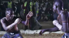 Fighters size each other up during a Dambe fight at the  Emir Ado Bayero Dambe Championship