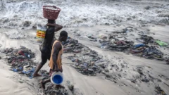 a beach coast in Accra inundated with textile waste 