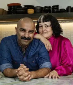 Um casal olhando para a câmera