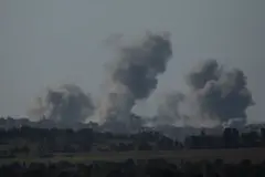 Smoke resulting from an explosion in the Gaza Strip, as seen from the Israeli side of the border on 26 December 2023