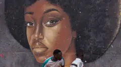 A mural showing a woman with a perfectly round afro.
