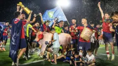 Chinese local football team celebrating tournament victory