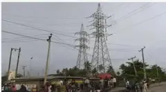 Aworan awọn eeyan nitosi opo agbara ina mọnamọna.