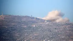 Smoke rises above the occupied West Bank