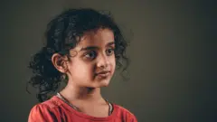 5 year old girl looking at camera