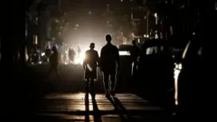 People walking in a darkened street in Havana, Cuba