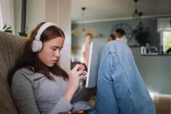 Jovem com fone de ouvido e computador