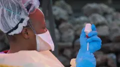 One nurse in protective gear dey prepare vaccine against Ebola for Goma for August 7, 2019
