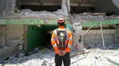 Anggota Basarnas membacakan doa untuk korban bangunan mushala di Pondok Pesantren (Ponpes) Al Khoziny di Kecamatan Buduran, Sidoarjo, Jawa Timur, Selasa (07/10).