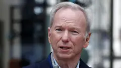 Close up of Eric Schmidt wearing a dark jacket and pinstriped shirt