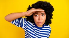 Woman looks embarrassed and hiding face