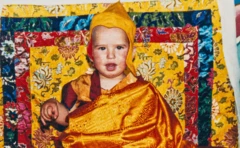 Osel Hita Torres as a child dressed in typical Buddhist monk attire.
