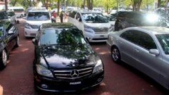 some luxury cars parked in a yard