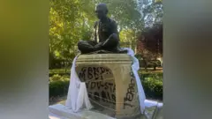 Graffiti on statue of independence hero Mahatma Gandhi in Tavistock Square, London 30 September 2025