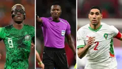 Victor Osimhen wear Nigeria dark green flowered jersey. Ghanaian referee Daniel Nii Ayi Laryea wear referee uniform wey be purple shirt and black shorts. Achraf Hakimi wear all white Morocco jersey