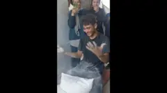 තිරිඟු පිටි මල්ලක් ලැබීමෙන් සතුටු වෙන ගාසා හි පවුලක් 