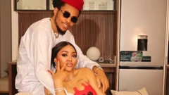 Samuel Ijegwu alias Sammy West wear red cap and white cloth dey hold her sister Regina Daniels wey wear red cloth