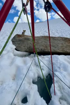 A estrutura de ancoragem construída pelos socorristas, com cordas verdes e vermelhas sobre o buraco